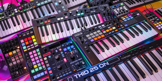 Colorful MIDI keyboards for beatmakers in a studio.