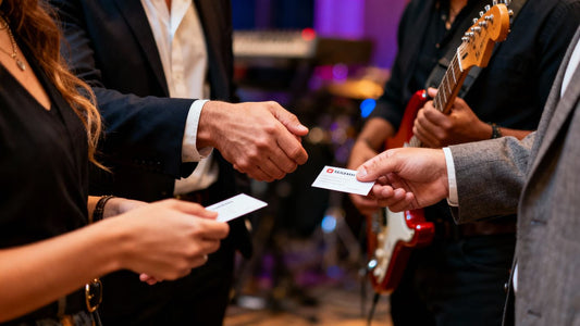 Producers networking and exchanging business cards at an event.