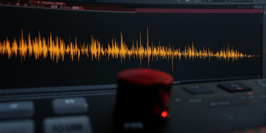 Close-up FL Studio with powerful 808 waveform.