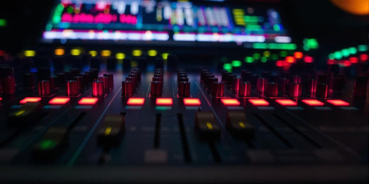 Close-up of a professional audio mixer with knobs.