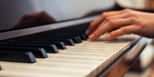 Close-up of piano keys with fingers playing chords.